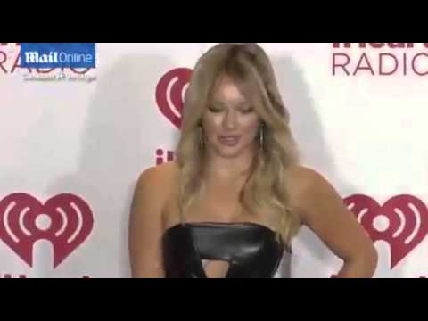 Hilary Duff shows off her cleavage in leather mini-dress