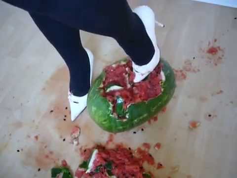 Jana crushes with her white high heel spike pumps a watermelon